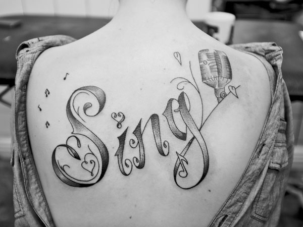 Awesome Sing Word Tattoo On Upper Back