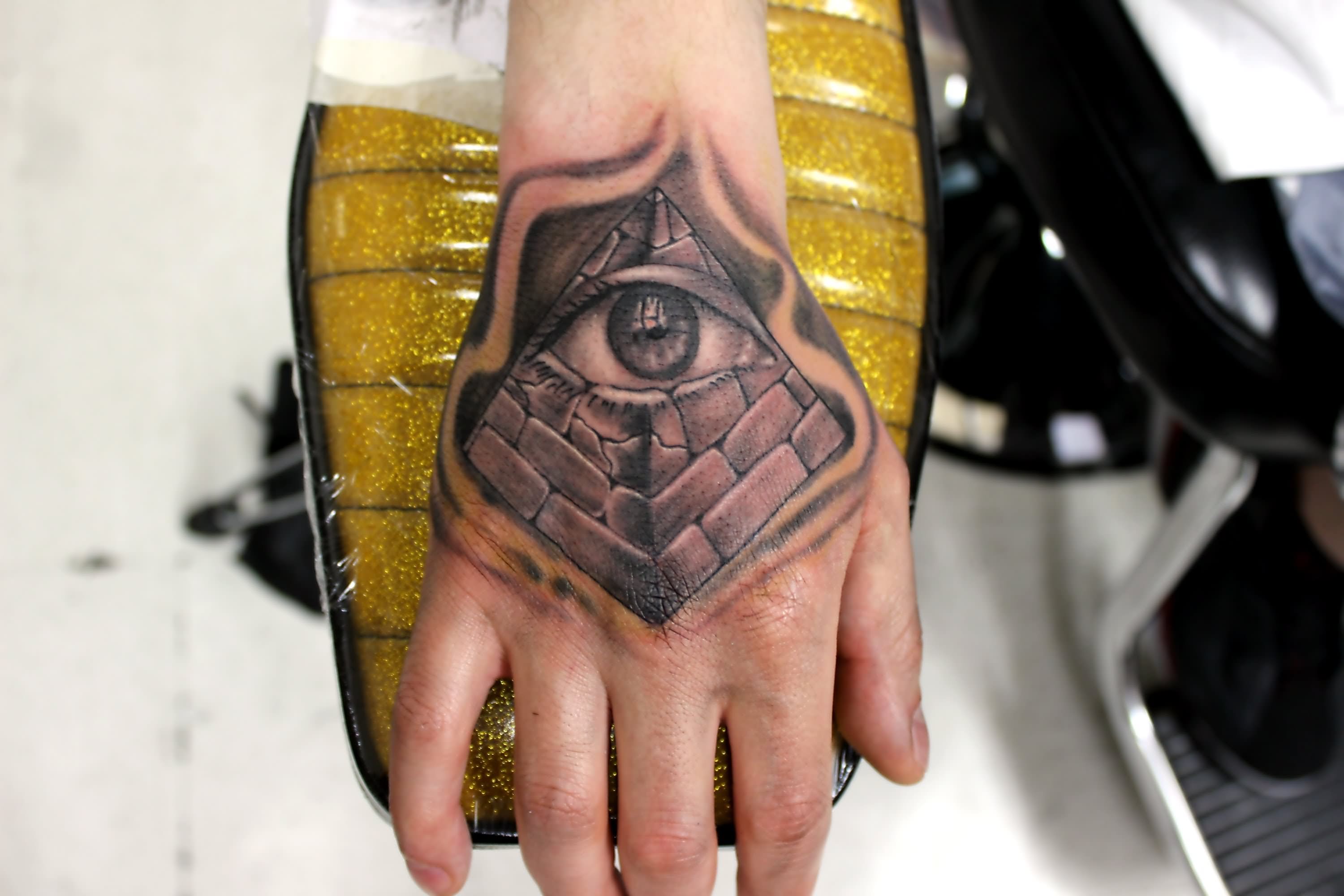 Black And Grey 3D Eye In Triangle Tattoo On Hand