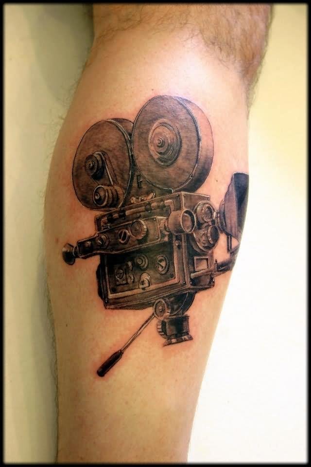 Black And Grey Cinema Tattoo On Back Leg