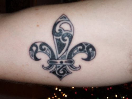 Black And Grey Tribal Fleur De Lis Tattoo On Muscles