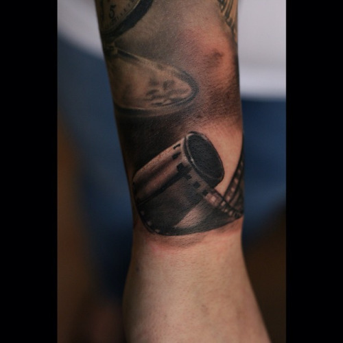 Black Ink Cinema Tattoo On Arm
