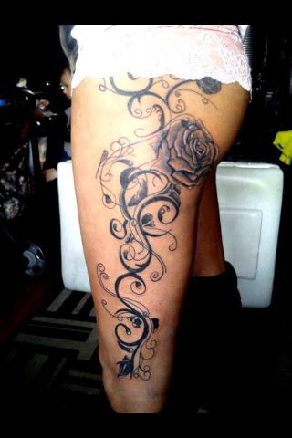 Black Ink Flowers Tattoo On Girl Left Upper Leg