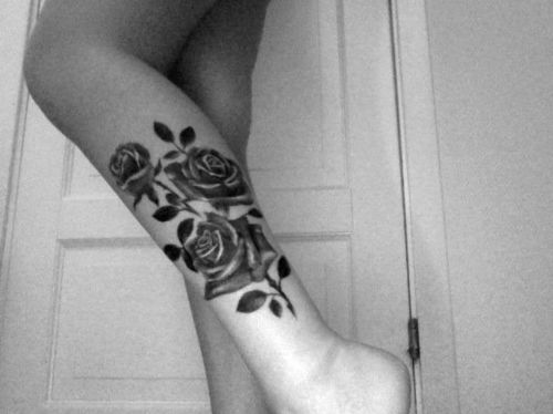 Black Ink Flowers Tattoo On Left Leg Calf
