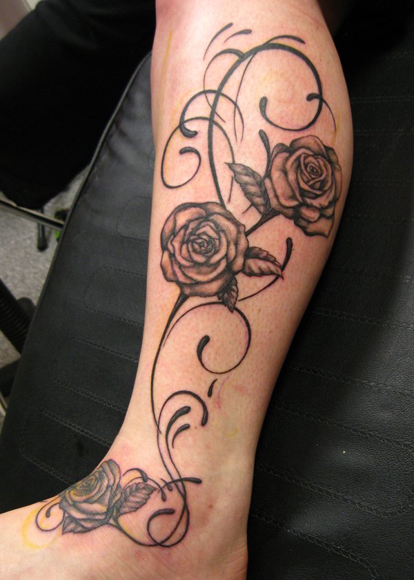 Black Ink Flowers Tattoo On Leg