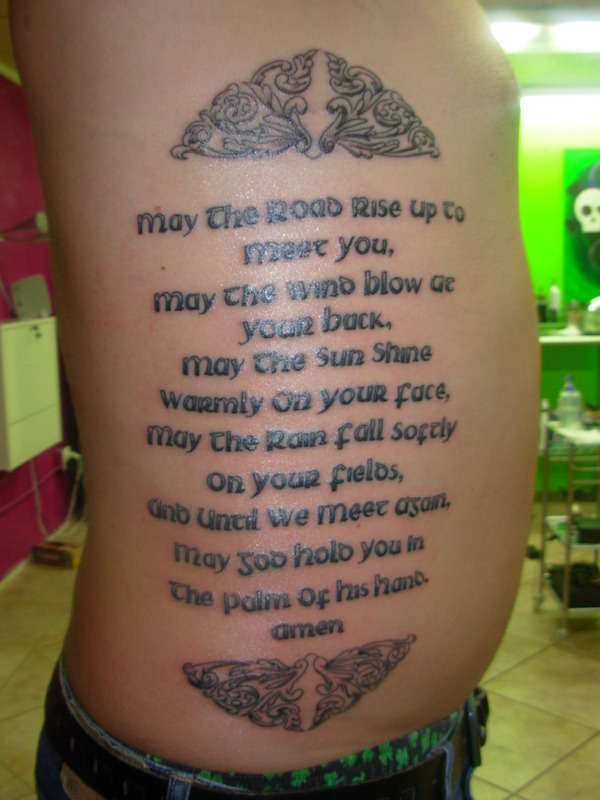 Black Ink Irish Quote Tattoo On Side Rib