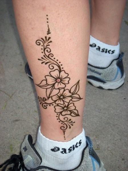 Black Outline Flowers Tattoo On Left Leg