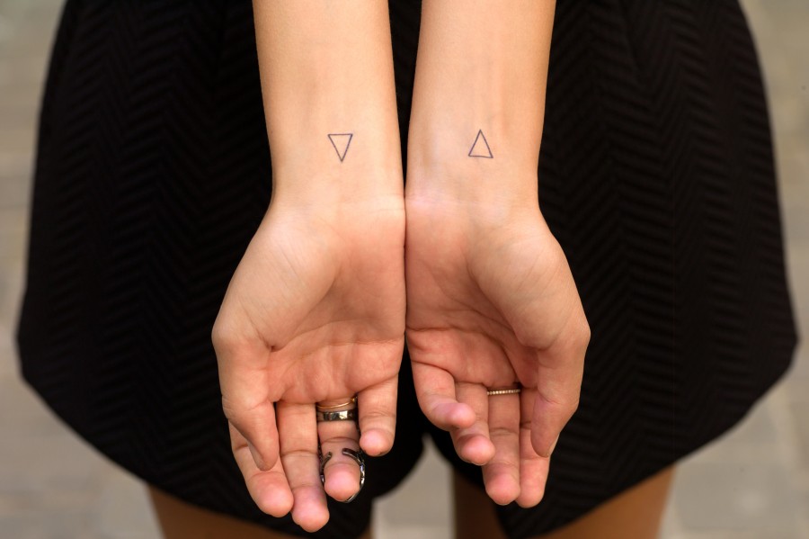 Black Outline Two Little Triangle Tattoo On Girl Wrist