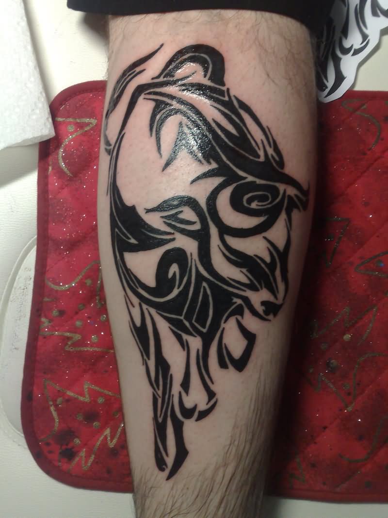 Black Tribal Bull Tattoo On Leg Calf