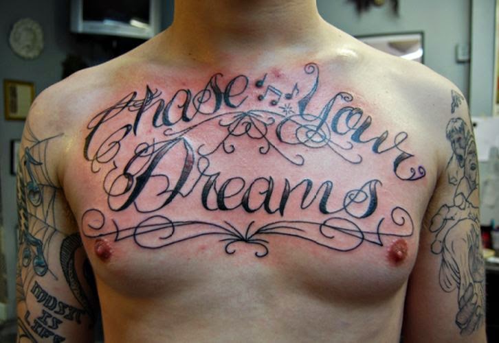 Chase Your Dreams Words Tattoo On Man Chest