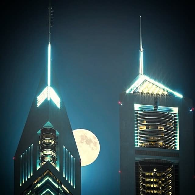Closeup Of Emirates Towers With Full Moon At Night