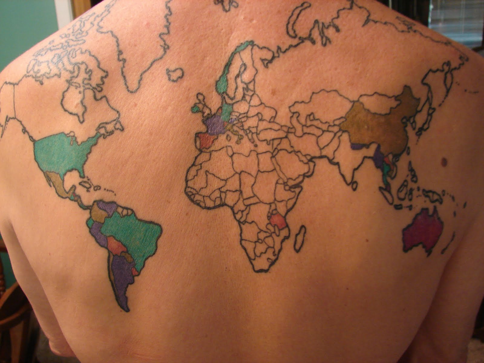 Country Map Tattoo On Upper Back