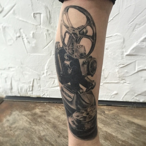 Dark Ink Cinema Tattoo On Leg