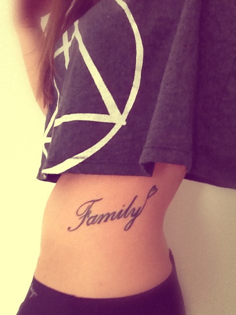 Family Word Tattoo On Girl Side Rib