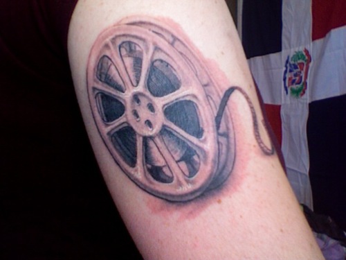 Film Reel Cinema Tattoo On Bicep