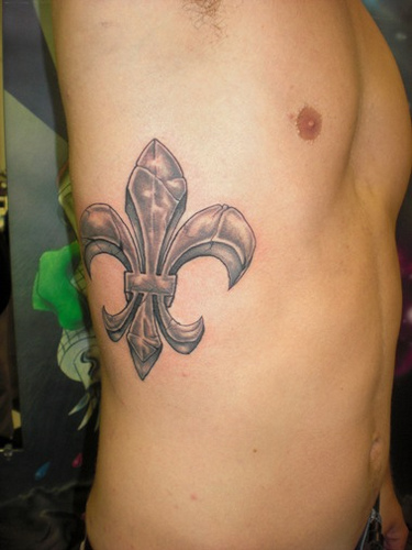 Fleur De Lis Tattoo On Man Side Rib