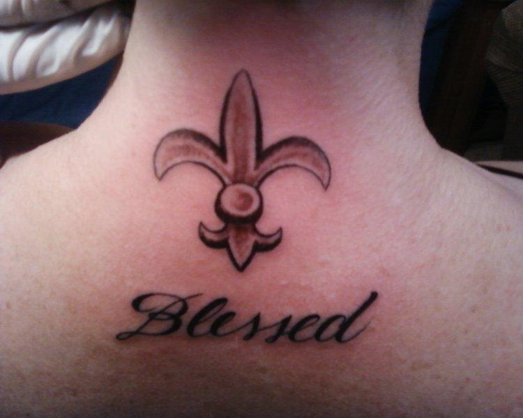 Fleur De Lis With Blessed Word Tattoo On Upper Back