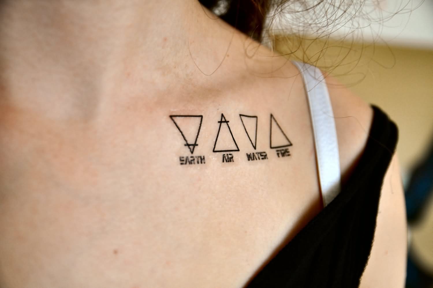 Four Triangle Tattoo On Girl Left Front Shoulder
