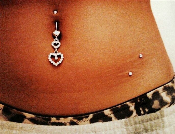 Girl With Beautiful Belly Piercing And Surface Hip Piercing