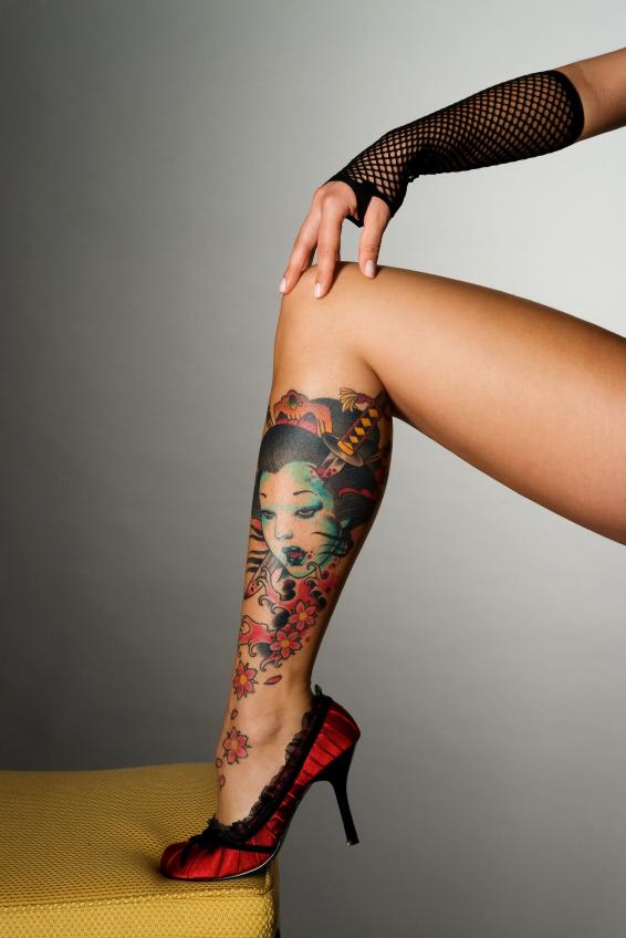 Girl With Flowers Tattoo On Leg
