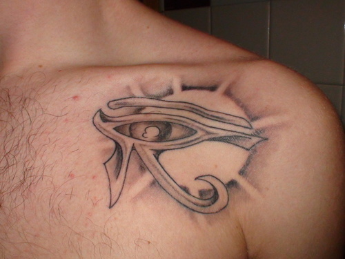Grey Egyptian Horus Eye Tattoo On Collarbone