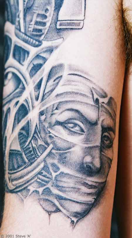 Grey Ink Egyptian Tattoo On Biceps