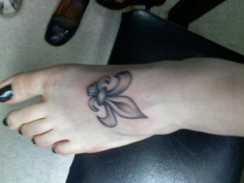 Grey Ink Fleur De Lis Tattoo On Left Foot For Girls