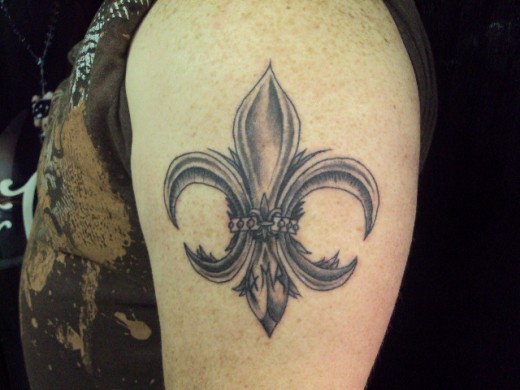 Grey Ink Fleur De Lis Tattoo On Left Shoulder