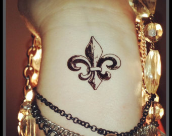 Grey Ink Fleur De Lis Tattoo On Left Wrist