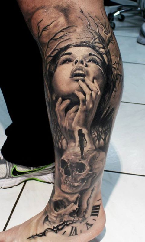 Grey Ink Girl Face With Skull Tattoo On Left Leg