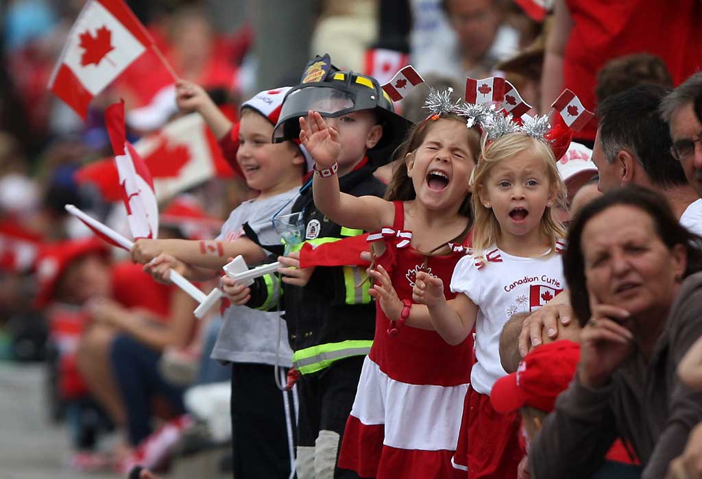 Kids Cheer On The Canada Day Parade Participants