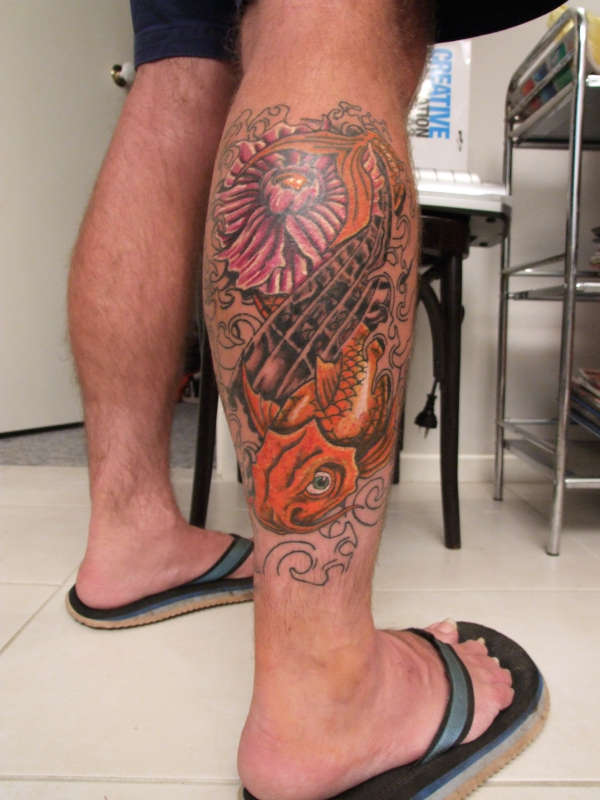Koi Fish With Flower Tattoo On Right Leg Calf