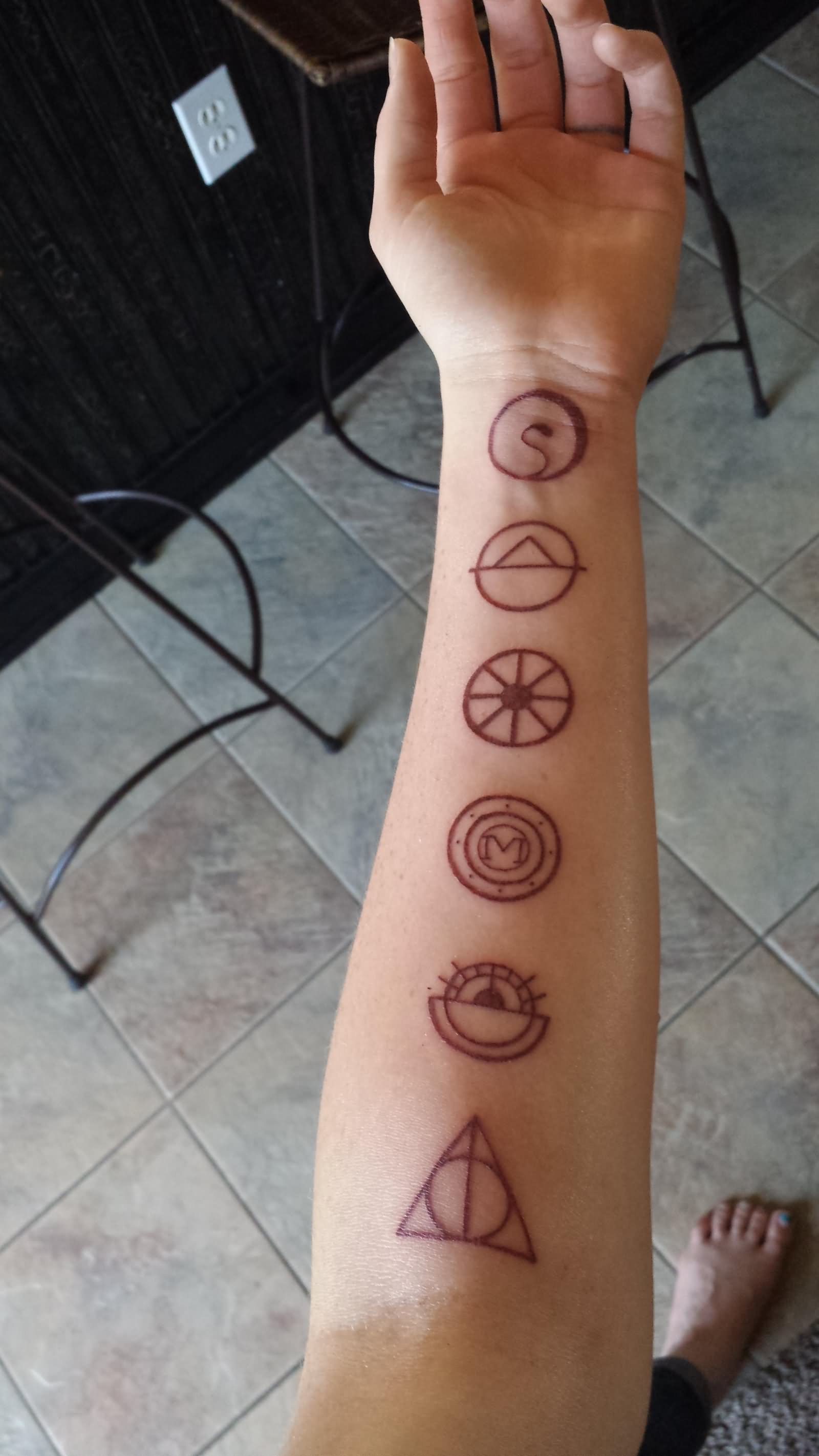Literary Symbols Tattoo On Left Forearm