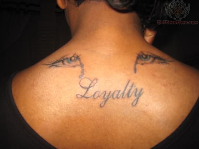 Loyalty Word With Crying Eyes Tattoo On Upper Back