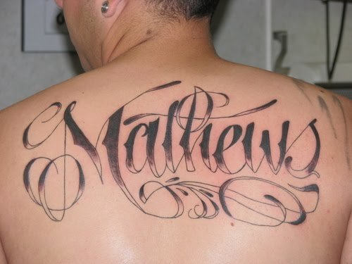 Mathews Word Tattoo On Man Upper Back