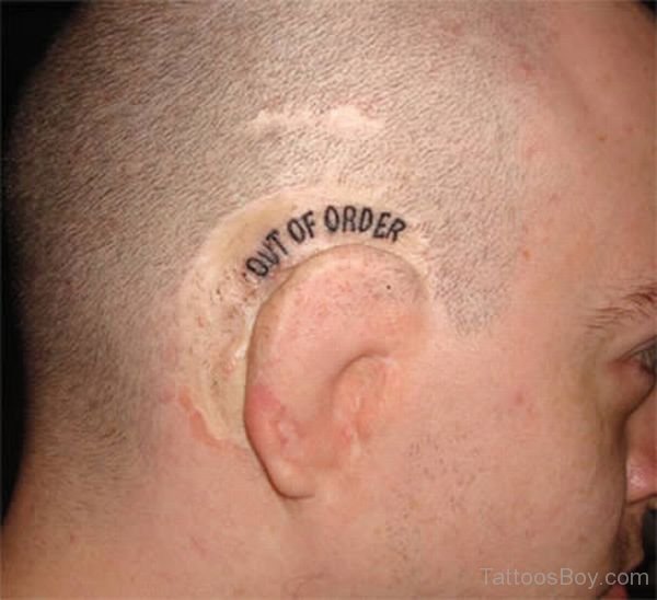 Out Of Order Word Tattoo On Behind The Ear