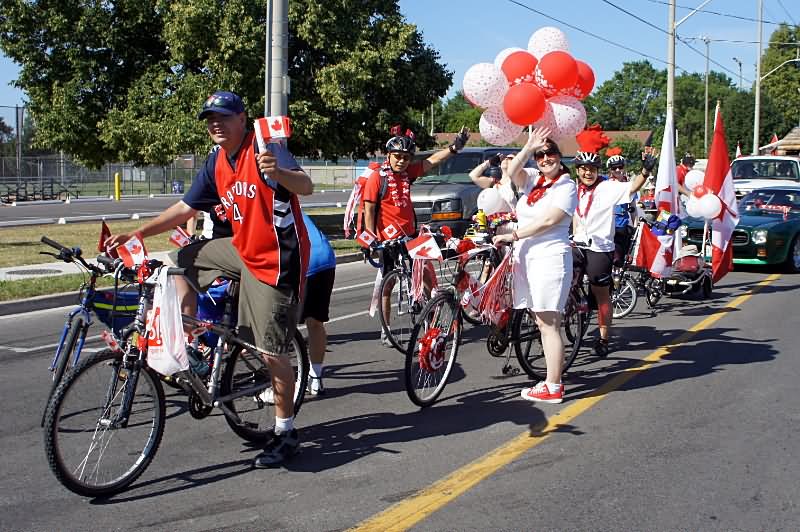 People Taking Part In Canada Day Parade On Bicycles