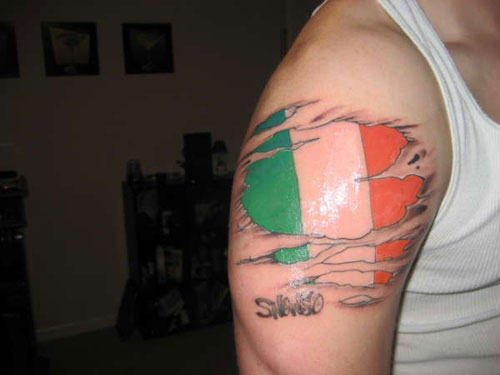 Ripped Skin Irish Flag Tattoo On Shoulder