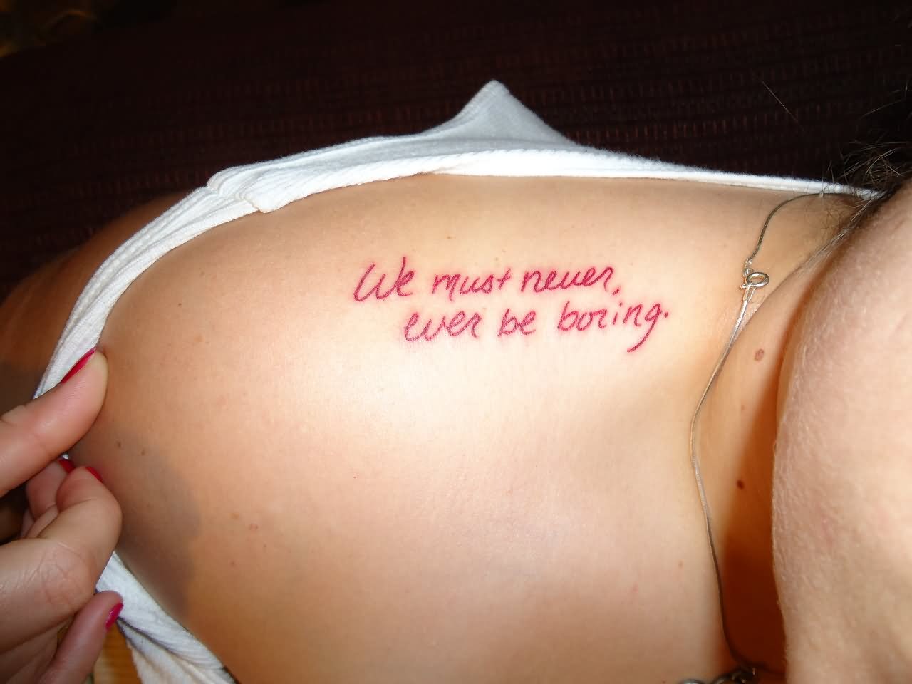 We Must Never Ever Be Boring Literary Tattoo On Girl Upper Shoulder