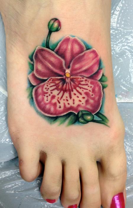 Amazing Color Orchid Tattoo On Girl Right Foot