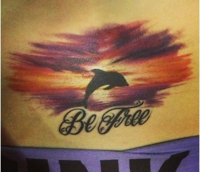 Be Free Dolphin Tattoo On Lower Back