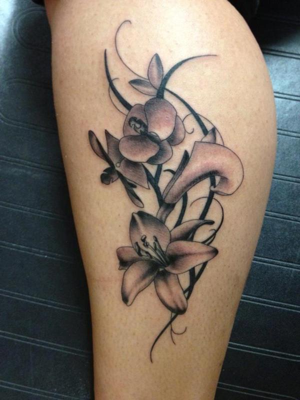 Black And Grey Tribal Orchid Tattoo On Leg