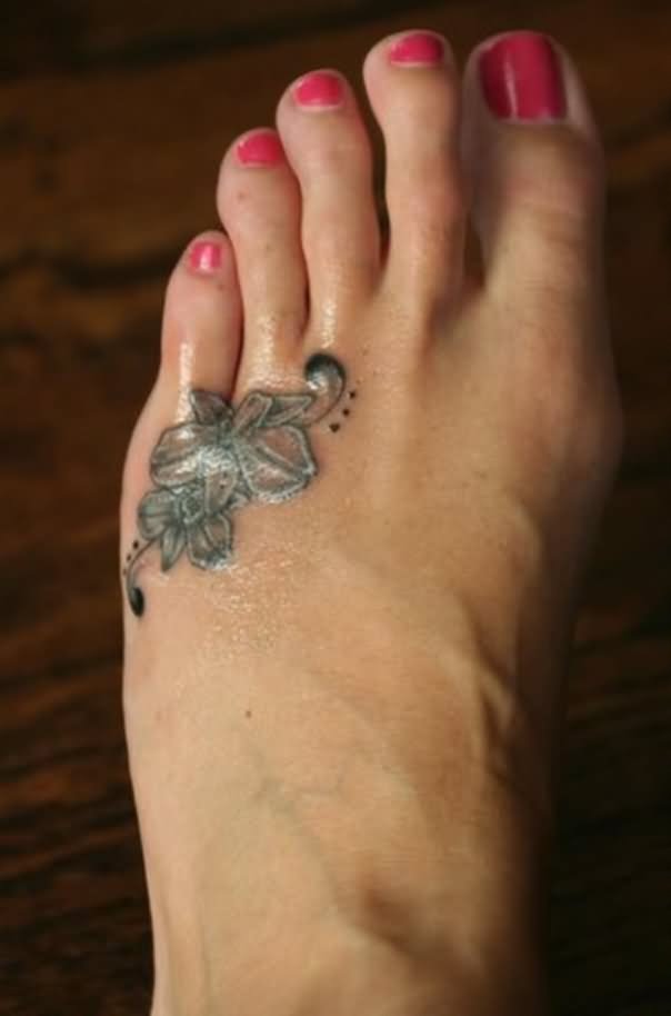 Black And White Orchid Tattoo On Girl Left Foot