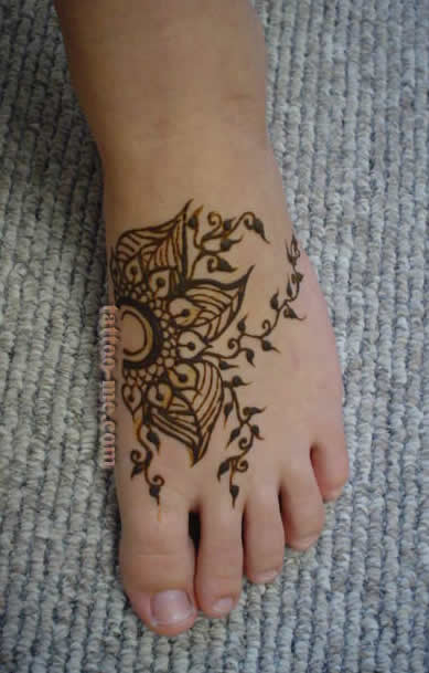 Black Flower Tattoo On Left Foot