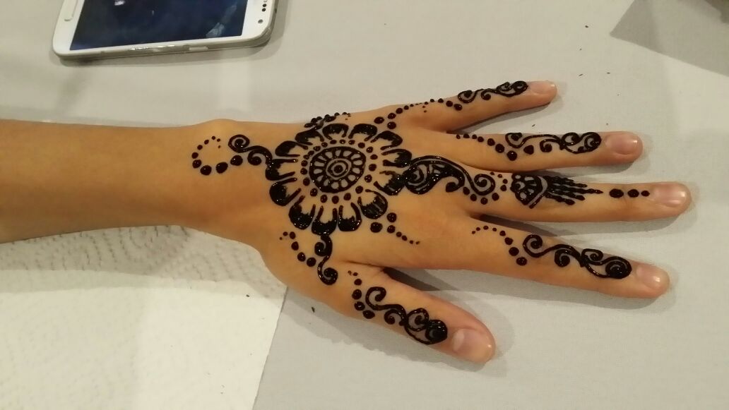 Black Henna Flowers Tattoo On Left Hand