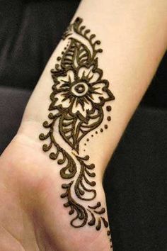 Black Simple Henna Flower Tattoo On Wrist