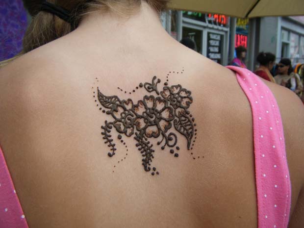 Black Simple Henna Flowers Tattoo On Upper Back