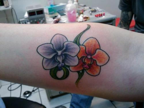 Blue And Orange Orchid Tattoo On Forearm