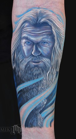 Blue Ink Wizard Tattoo On Forearm