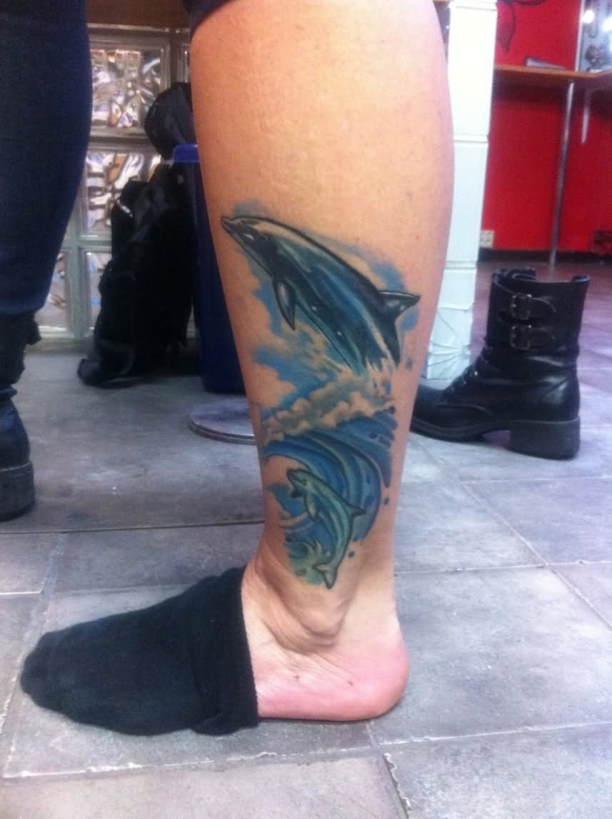 Blue Water And Dolphin Tattoo On Side Leg