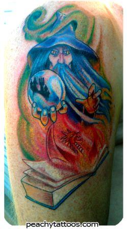Colored Wizard With Crystal Ball Tattoo On Left Shoulder